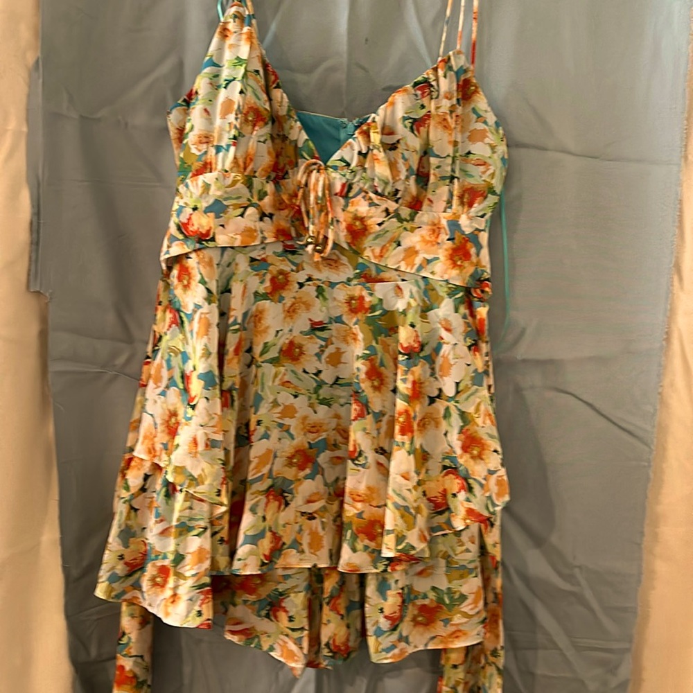 A romper greenish yellow red with a little brown peach tap in the back